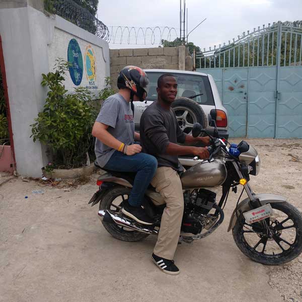 Two people sitting on a motorcycle.
